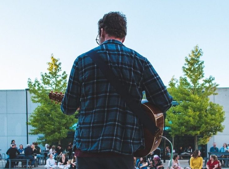 A man performs at a Campus open mic night