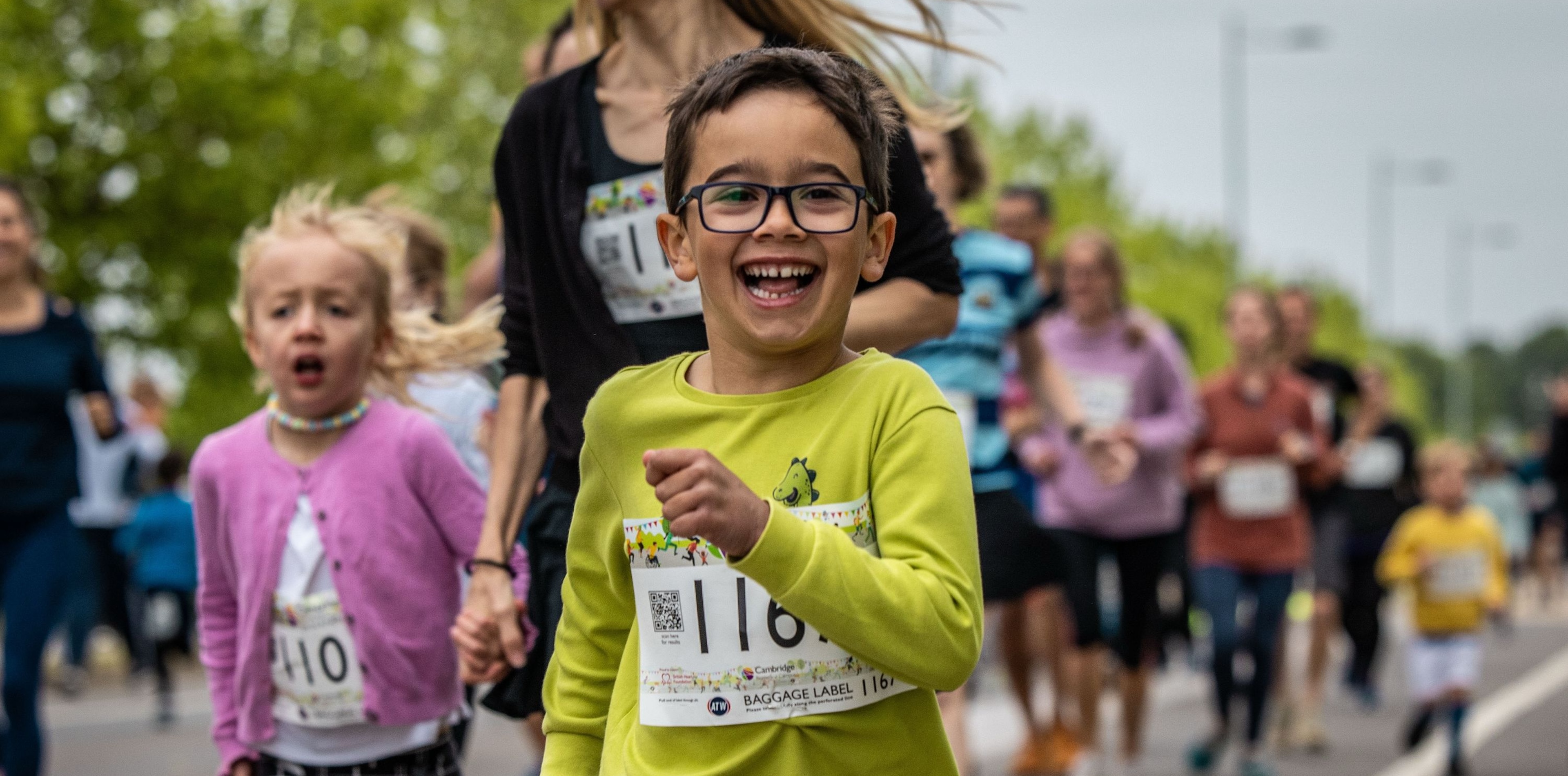 A boy smiles as he runs